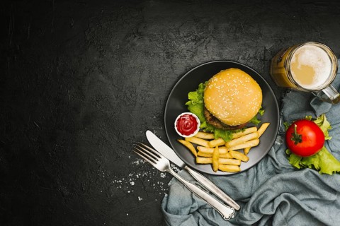 Flat lay burger and fries on plate with copyspace
