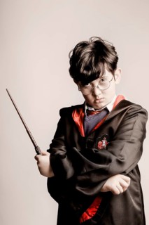 Boy with glasses in Harry Potter costume