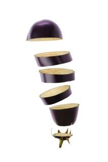 Levitating slices of fresh eggplant. World vegan day concept
