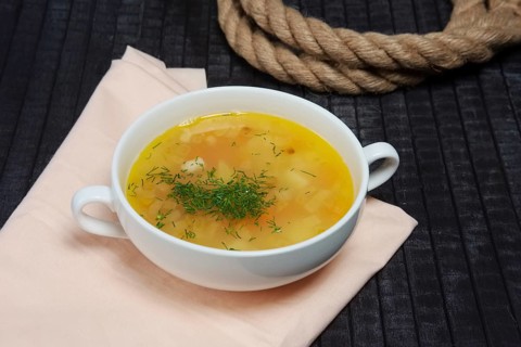 A bowl of clean pea soup with smoked ham