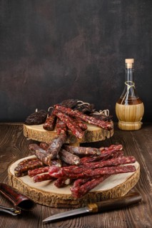 Different kinds of sausages on wooden background