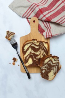 Marble cake on wooden board and fork