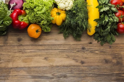 Flat lay vegetables assortment wooden background