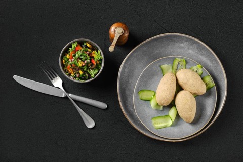 Top view of semifinished frozen cepelinai. Potato dumplings stuffed with ground meat
