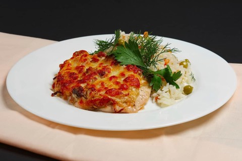 Plate with baked chopped chicken fillet with cheese and rice