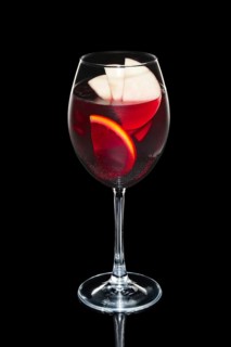 Cold sangria in wine glass with water spray
