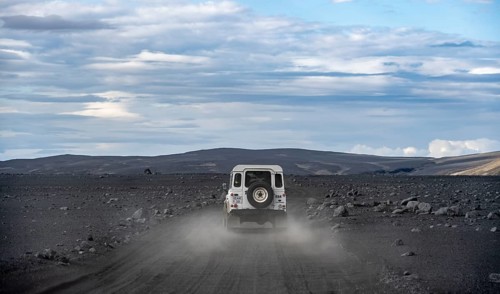 White Land Rover on a dirt road