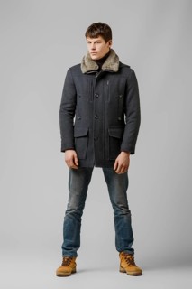 Full length portrait of handsome man in warm winter coat posing in studio