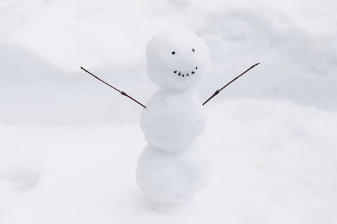 Funny snowman snow bank