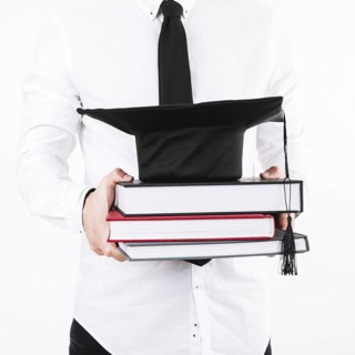 Man holding books mortarboard
