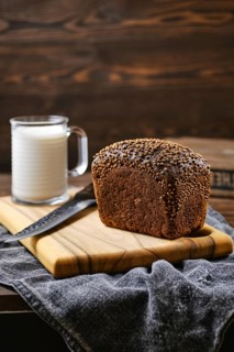 Fresh rye brown bread on wooden cutting board