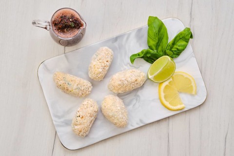 Top view of brown salmon meat cutlet in cheese breading