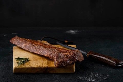 Smoked beef striploin meat on cutting board