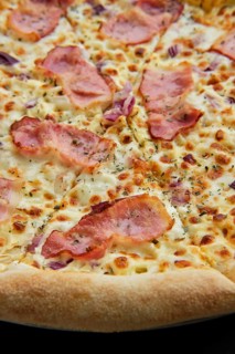 Macro photo of pizza carbonara with bacon and onion