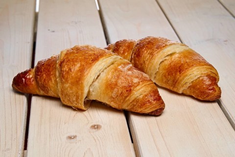 A pair of fresh croissant on the table