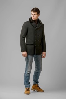 Full length portrait of handsome man in warm woolen coat posing in studio