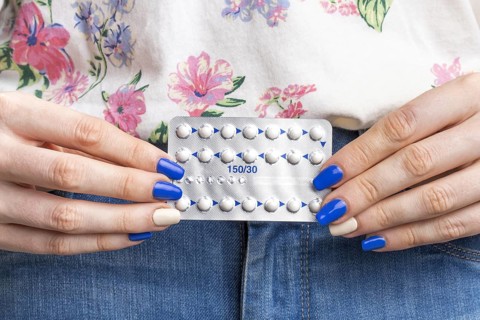 Close up woman holding pills tablet