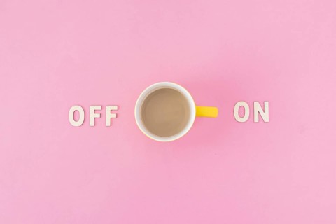 Coffee cup near off writings