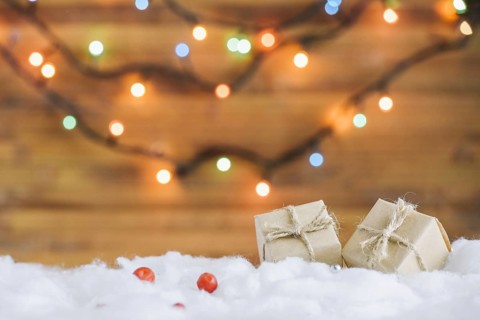 Present boxes decorative snow near fairy lights