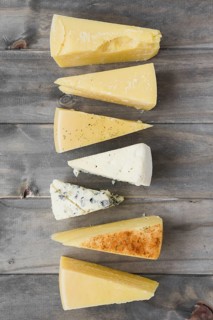Triangular cheese chunk arranged row wooden plank. Resolution and high quality beautiful photo