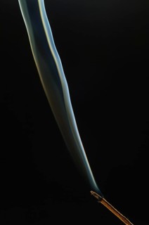 Trajectory of incense smoke in the air showing different shapes. France