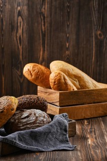 Assortment of cereal bread made of different seeds on wooden table