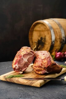 Air dried lamb neck meat on wooden cutting board