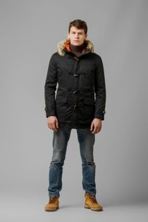 Full length portrait of handsome man in warm winter coat posing in studio
