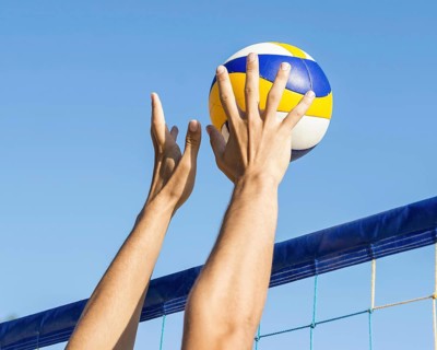 Man s hands preparing hit incoming volleyball net