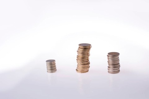 Turkish Lira coins on three piles on white background