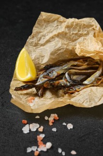 Fatty smoked smelt in wrapping paper