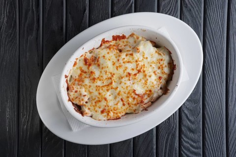 Lasagna Italian cuisine. Top view. Plate on a wooden background