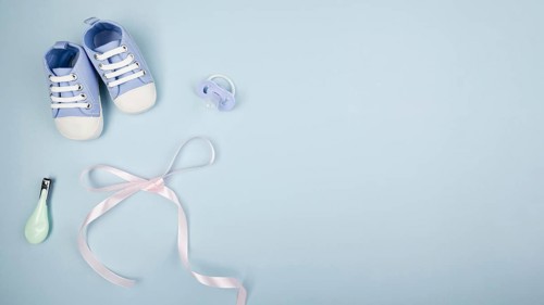 Ribbon with baby shoes copy space