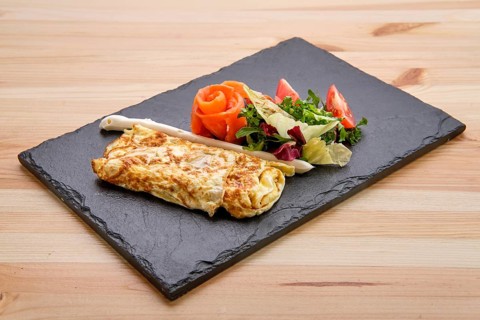 Omelette with salmon on slate plate
