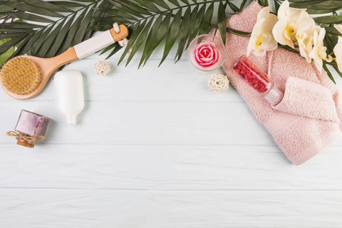 Towel salt bottle brush flowers leaves wooden background. Resolution and high quality beautiful photo