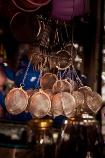 Group of metal strainers hanging in the view