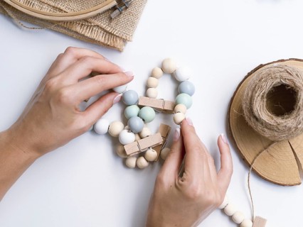 Woman making decorations with wood beads. Resolution and high quality beautiful photo