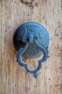 Old Handmade ottoman door knob on wood