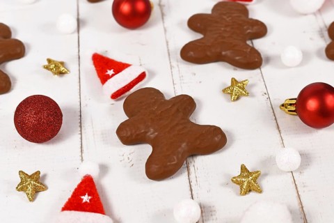 German gingerbread in shape of men glazed with chocolate between Christmas decoration