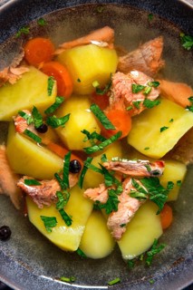 Macro photo of red salmon fish soup with potato and carrot