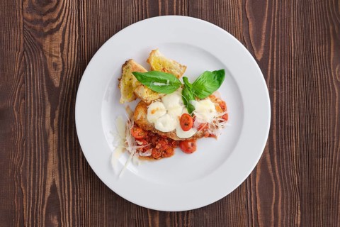 Top view of roasted chicken fillet with tomato cherry