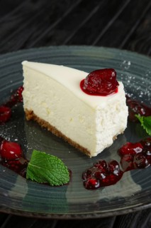 Closeup view of cheese cake decorated with cherry