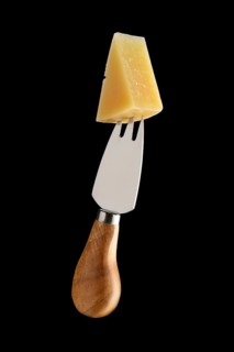 Cheese fork with piece of parmesan on it isolated on black background