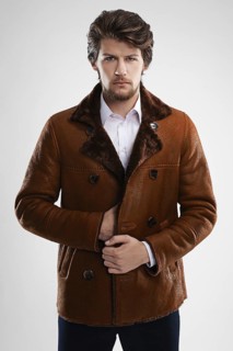 Brutal handsome unshaven man with beard and moustache in sheepskin coat with fur collar