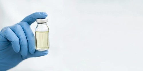Front view doctor hand holding vaccine with copy space