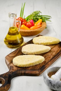 Semifinished homemade zander cutlet on a wooden serving board