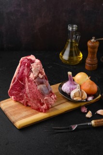 Raw porterhouse steak with spice and seasoning ready for cooking