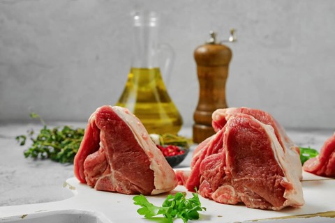 Uncooked boneless rack of lamb on cutting board