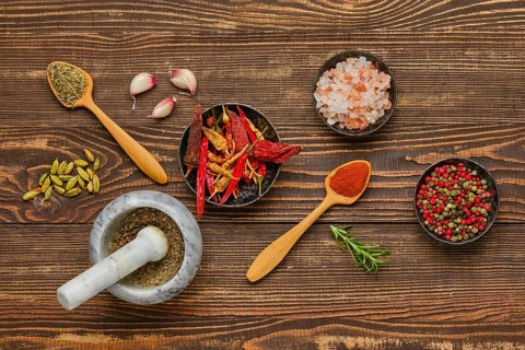 Overhead composition with spicy spice and seasonings on wooden background