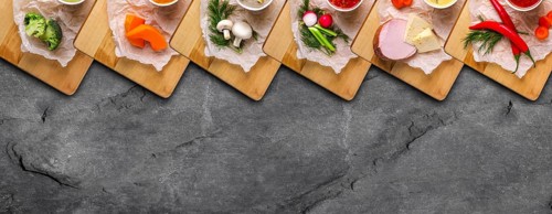 Variety of colorful vegetables and ingredients for cream soups top view on stone background